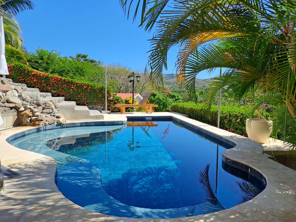 Coconut trees of Casa Bella Montaña, home for sale at Samara Beach, Guanacaste, Costa Rica