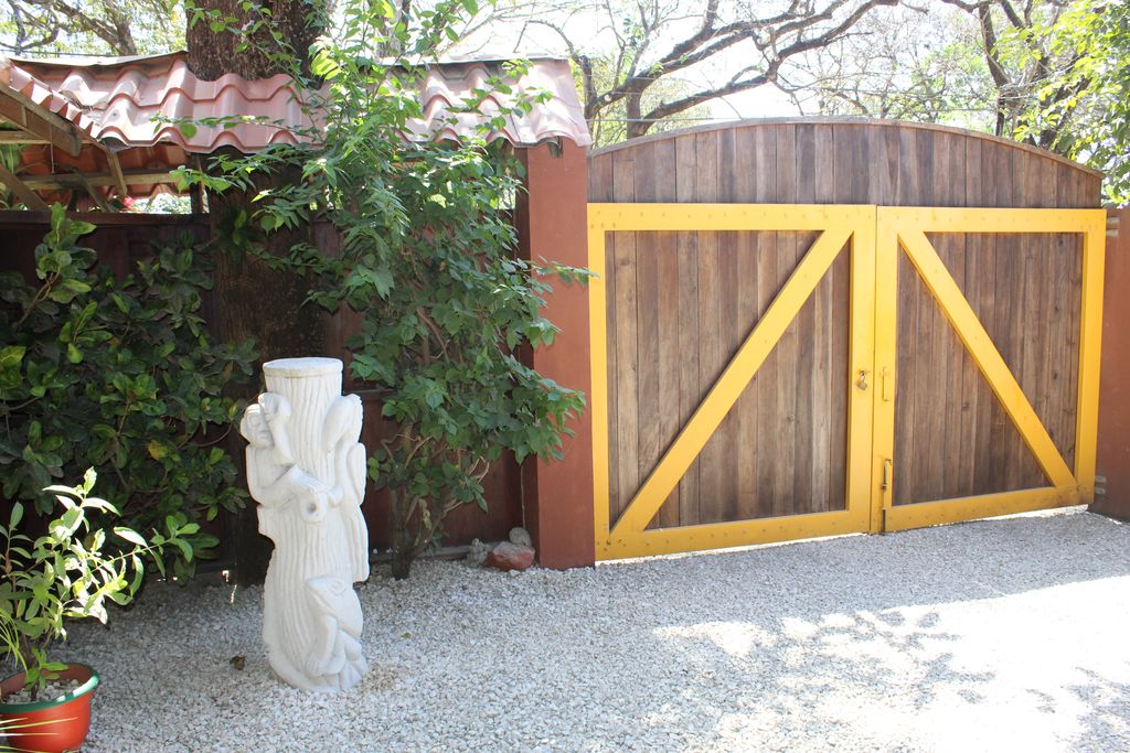 Beautiful wooden gate of Hotel Las Palmas, business for sale at Samara Beach, Costa Rica