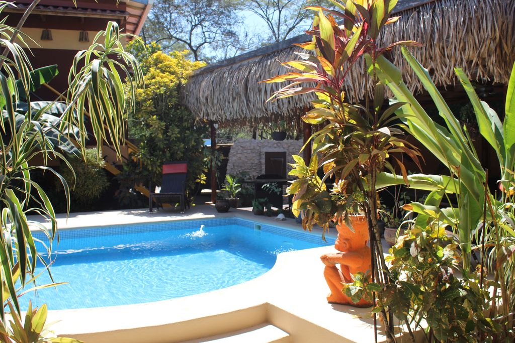 Statues on the pool terrace of the Las Palmas hotel, business for sale at Samara Beach, Costa Rica