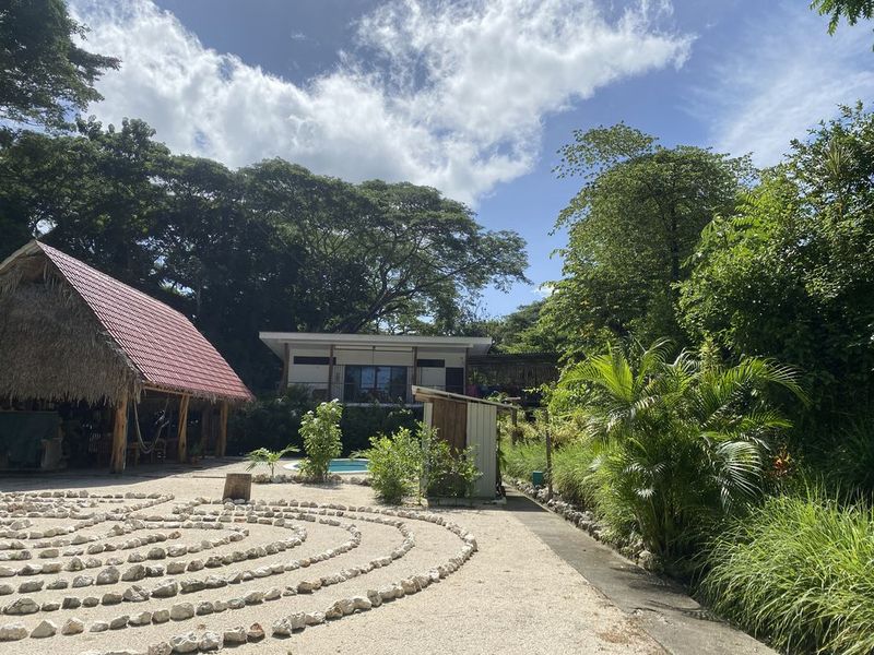 garden view with deck and pool at the holistic yoga retreat hotel for sale samara guanacaste costa rica