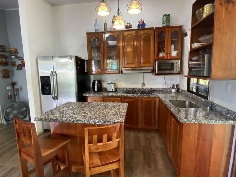 wooden kitchen with granit countertop in Casa Munoz home for sale samara costa rica